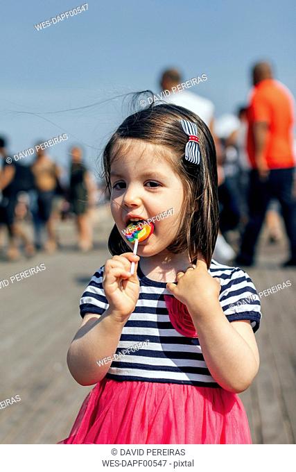 USA, New York, Coney Island, little girl with lollipop