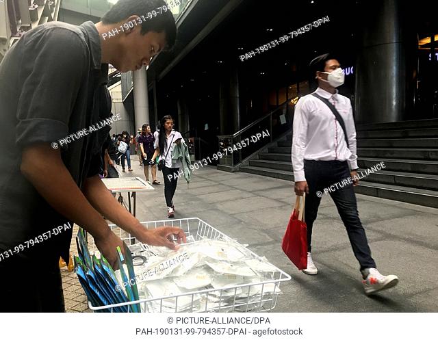 31 January 2019, Thailand, Bangkok: A salesman sorts respirator masks to protect against smog. Due to the ongoing smog over Bangkok