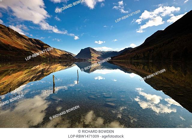 England, Cumbria, Buttermere. The surrounding mountainside reflected in the calm waters of Buttermere lake