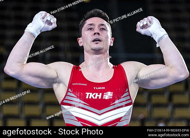 12 June 2021, Bavaria, Munich: Gymnastics: Olympic qualification, men: Andreas Toba cheers on the rings. Photo: Tom Weller/dpa