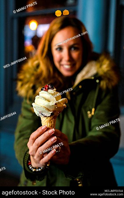 Mid adult woman holding ice cream