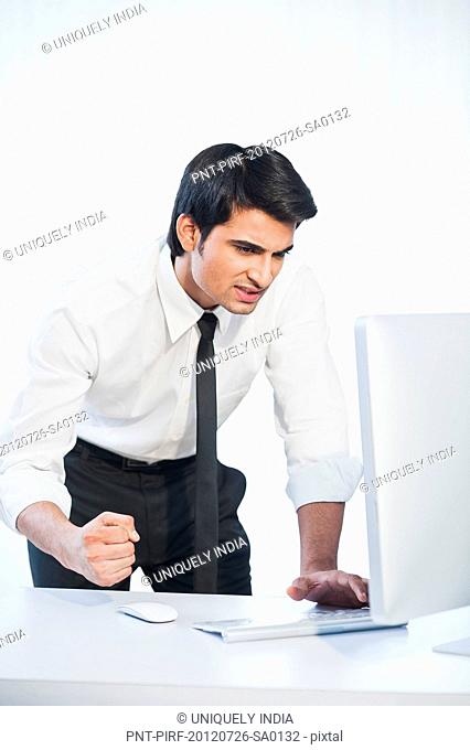 Businessman looking at a desktop pc