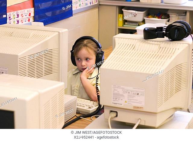 Toledo, Ohio - A kindergarten girl works on a computer at East Side Central Elementary School in the Toledo public school system