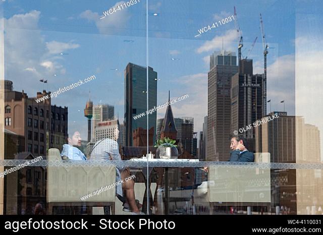Sydney, New South Wales, Australia - The city skyline of the business district with its high-rise buildings is reflected in a window pane of the Park Hyatt...