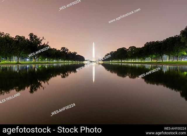 USA, Washington DC, Washington Monument reflecting in Lincoln Memorial Reflecting Pool at night