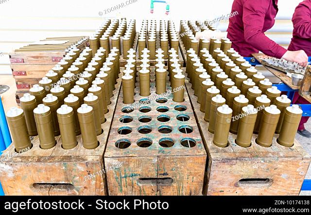 RPG explosive elements of anti tank rocket-propelled grenades (RPGs, bazooka) near an assembly line in a munition factory