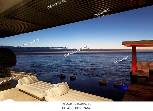 Sofas and infinity pool overlooking ocean