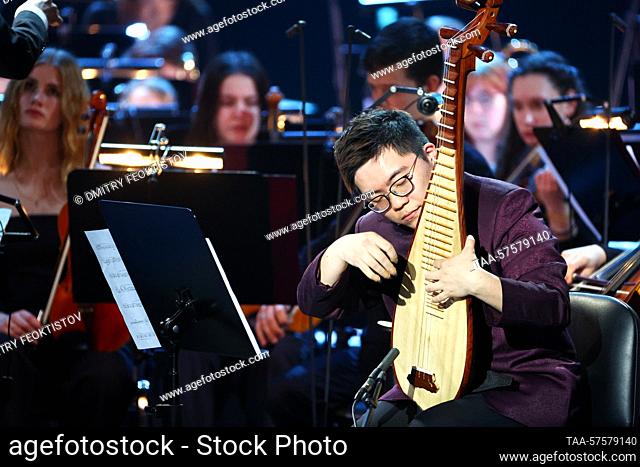 RUSSIA, SOCHI - FEBRUARY 26, 2023: Pipa player Leung Ka Lok (R front) performs with the All-Russian Youth Symphony Orchestra are seen during a gala evening on...