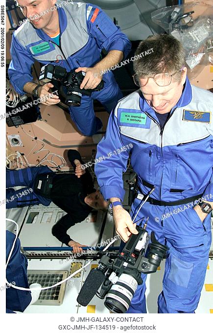 Two Expedition One crew members prepare to greet and photograph their newest visitors aboard the International Space Station (ISS) soon after the STS-98...