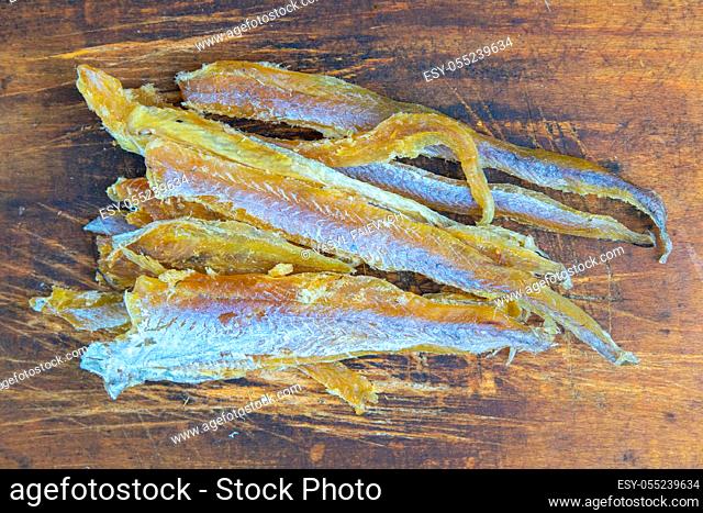 Dried tuna fillet on wooden background. Snack on fish with beer. Close-up