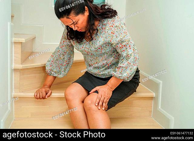 Asian senior woman wearing elastic support knee brace for reduce pain