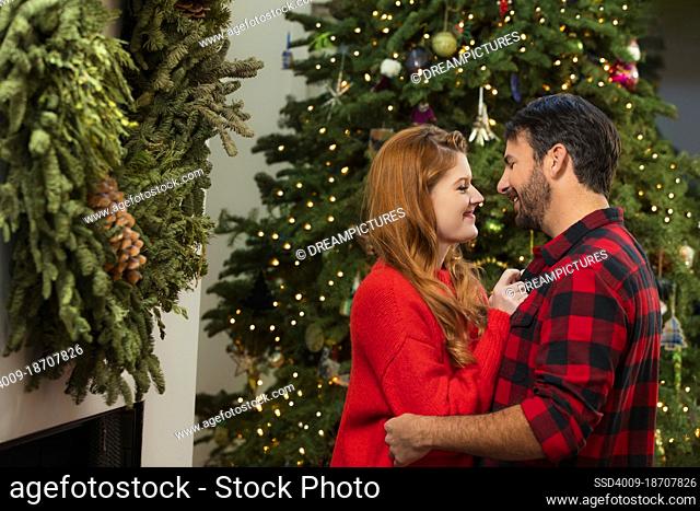 Couple kissing at home during Christmas