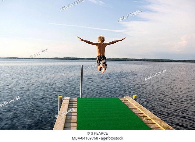Footbridge, boy, jump, water, island Bogö, Denmark