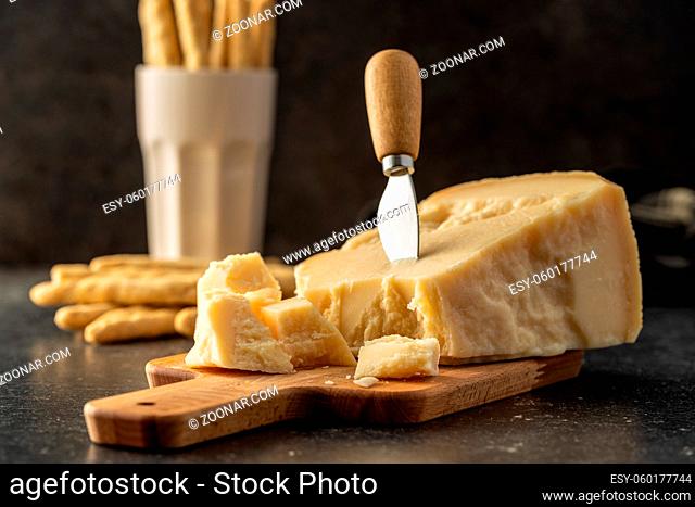 Pieces of italian parmesan cheese. Block of parmesan on kitchen table