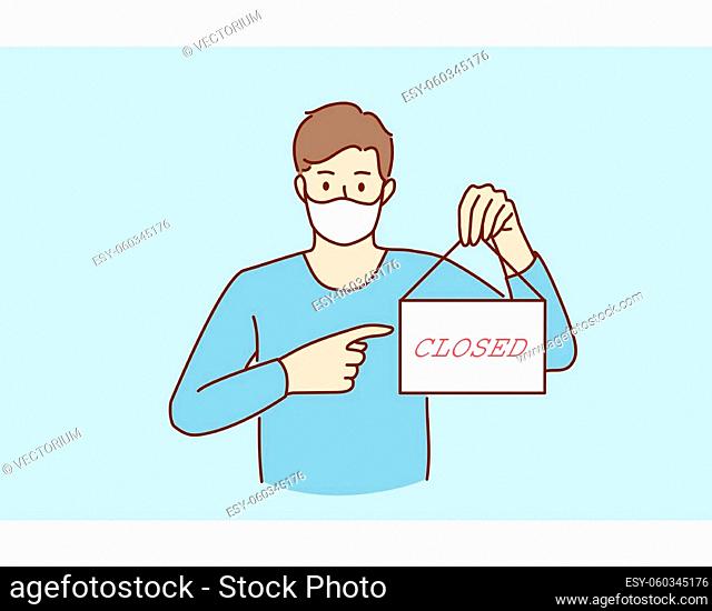 Business crisis during pandemic concept. Young sad man in protective medical mask standing showing sign with closed word during covid epidemic concept vector...