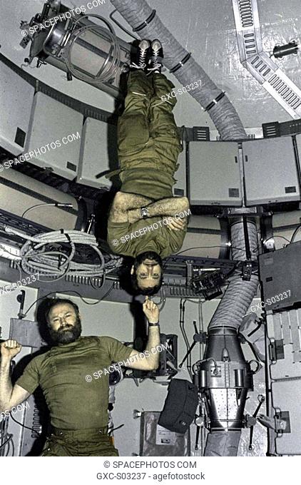 Astronaut Gerald P. Carr, Commander for the Skylab 4 mission, jokingly demonstrates weight training in zero-gravity as he balances astronaut William R