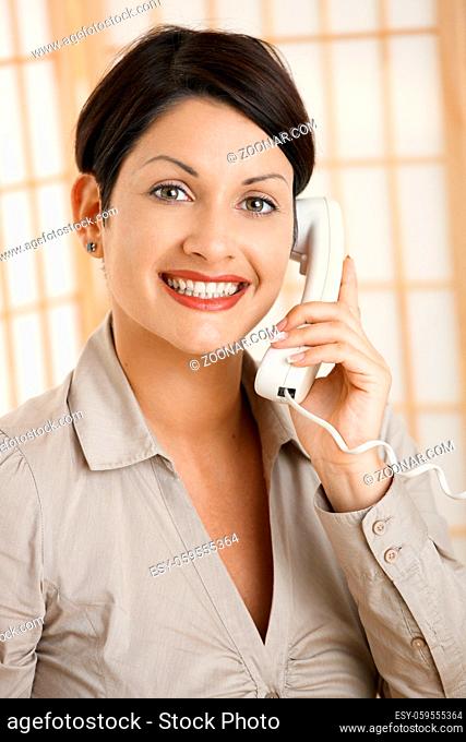 Closeup portrait of happy woman talking on phone, smiling