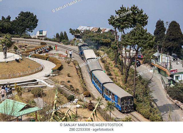 The Darjeeling Himalayan railway takes a 360 degree turn on the Batasia loop and war memorial in Ghum, West Bengal, India