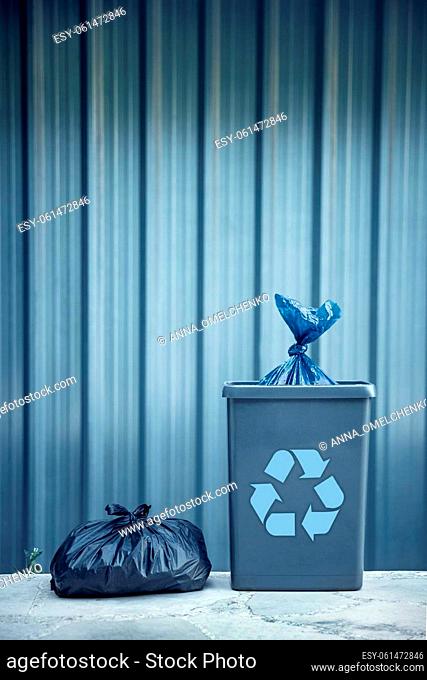 Photo of a Sorted Garbage in the Plastic Biodegradable Bags. Trash Can over Steel Background. Recycle to Save the Planet from Waste and Pollution