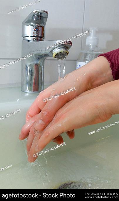 ILLUSTRATION - 27 February 2020, Brandenburg, Sieversdorf: A girl washes her hands with soap and water (posed photo). Hand hygiene measures are among the most...