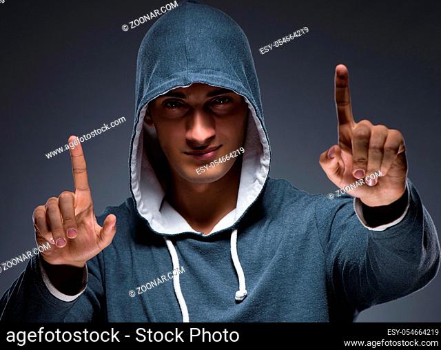 The young man wearing hoodie pressing virtual buttons
