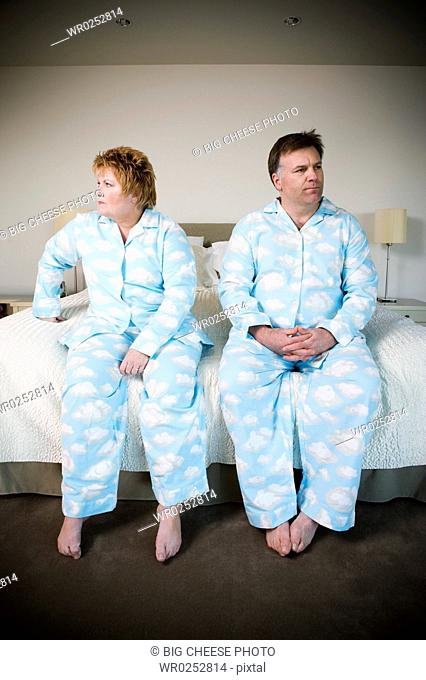 Upset couple in matching pajamas