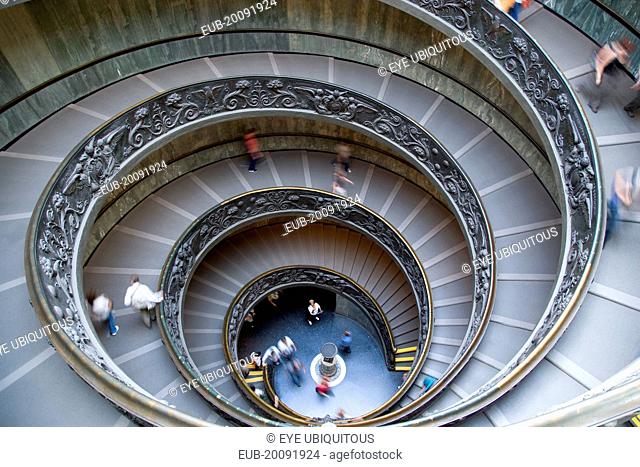 Vatican City Museums Tourists descending the Spiral Ramp designed by Giuseppe Momo in 1932 leading from the museums to the street level below