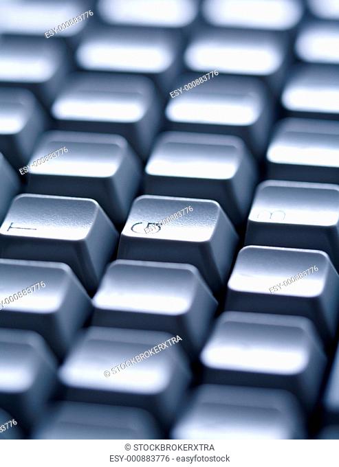 Close-up of several keys of computer keyboard with English letters on them