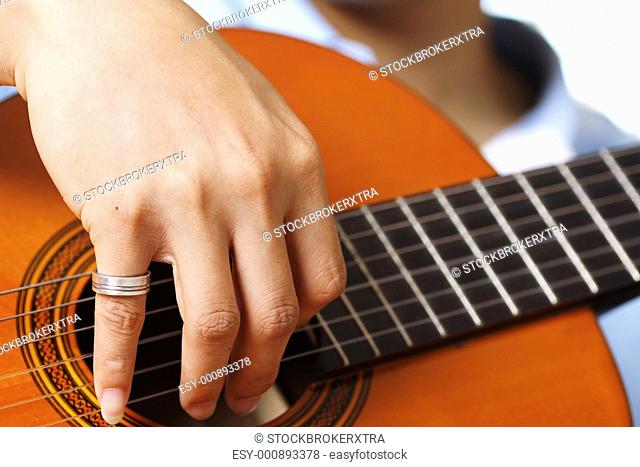 A guitar player strumming his guitar