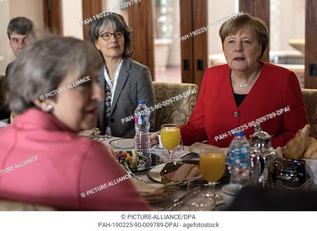 25 February 2019, Egypt, Sharm El-Sheikh: German Chancellor Angela Merkel (R) meets with British Prime Minister Theresa May (L) during a working breakfast on...