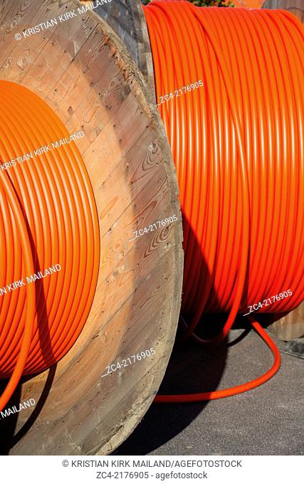 Huge orange cable drums for optic fibre connections