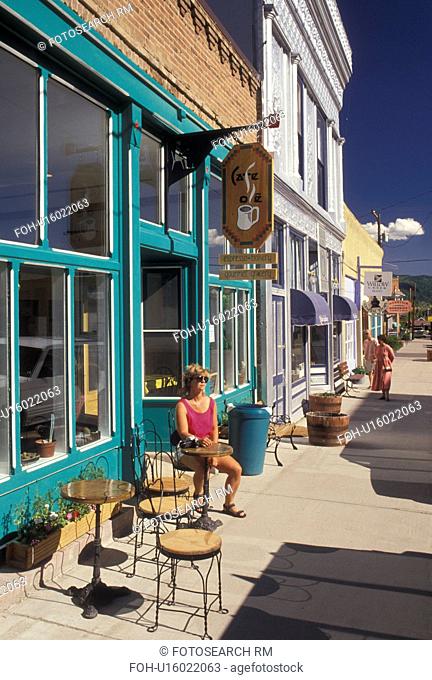 cafT, CO, Creede, Colorado, Woman sitting at an outdoor cafT in the Silver Mining Town of Creede