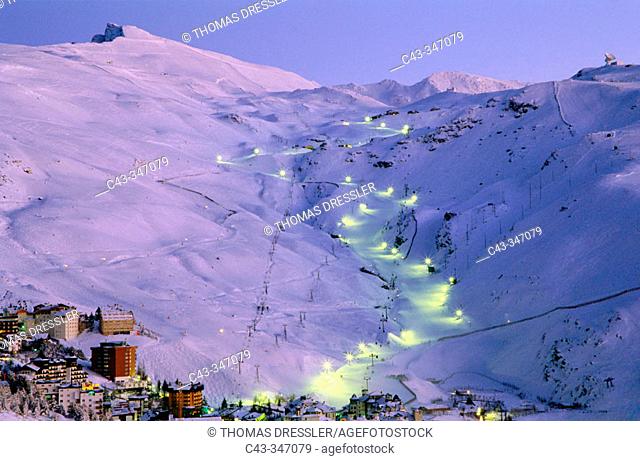 Snowy January landscape in Solynieve skiing resort by Pico Veleta, Sierra Nevada: the central run is illuminated only in Saturday evenings