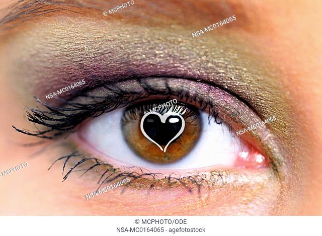 Brown woman's eye with a heart