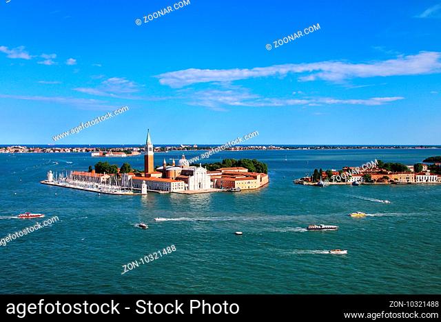 Aerial view of San Giorgio Maggiore Island in Venice, Italy. Venice is situated across a group of 117 small islands that are separated by canals and linked by...