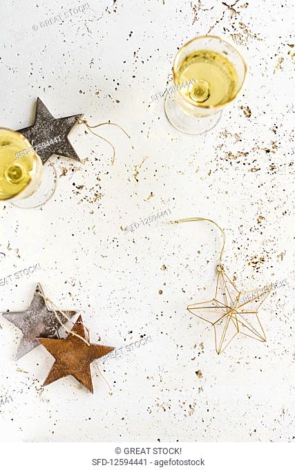 Two glasses of champagne and christmas decoration stars