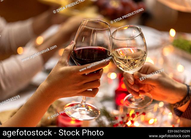 close up of hands toasting wine at christmas party