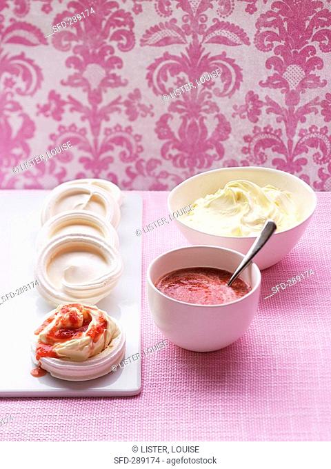 Meringue nests with strawberry coulis and cream