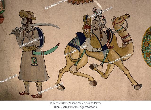 Rajasthani couple riding on camel, pune, maharashtra, india, asia