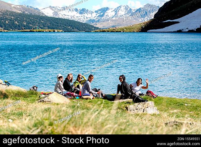 Canillo, Andorra : 2020 26 may : Young people Beautiful Querol Lake in the mountain refuge in the Incles Valley, Canillo, Andorra