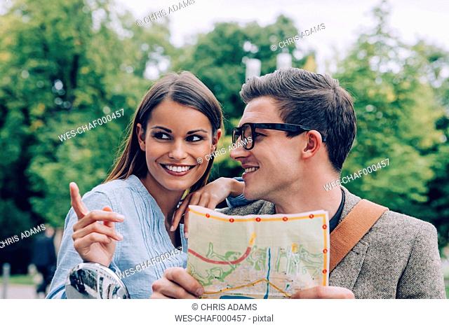 Young couple holding map looking for right direction