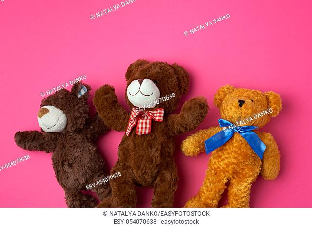 three teddy bears on a pink background, friendship concept, close up