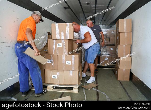 RUSSIA, DONETSK - AUGUST 28, 2023: People unload boxes of humanitarian aid delivered from the Moscow Region for Knowledge Day, the start of the school year