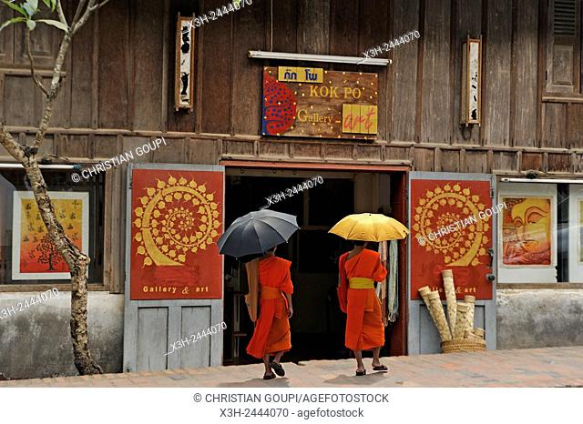 novice monks beside the Kok Po Art Gallery, Luang Prabang, Laos, Southeast Asia