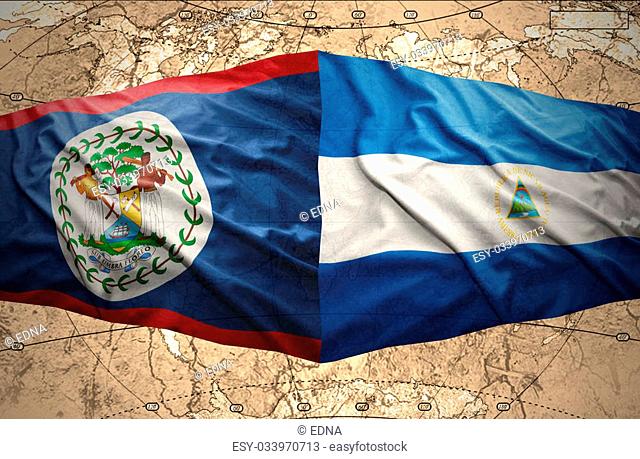 Waving Nicaraguan and Belize flags on the of the political map of the world