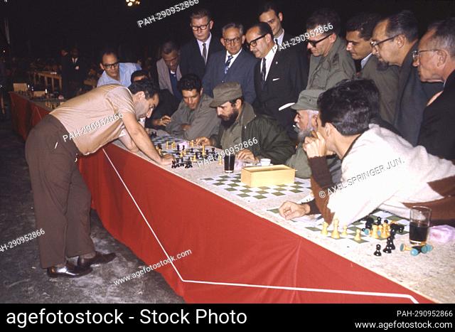 Fidel Castro sits at a chessboard, chess, in 1967 in Cuba; Participants in a simultaneous chess competition with the Russian world chess champion Tigran...