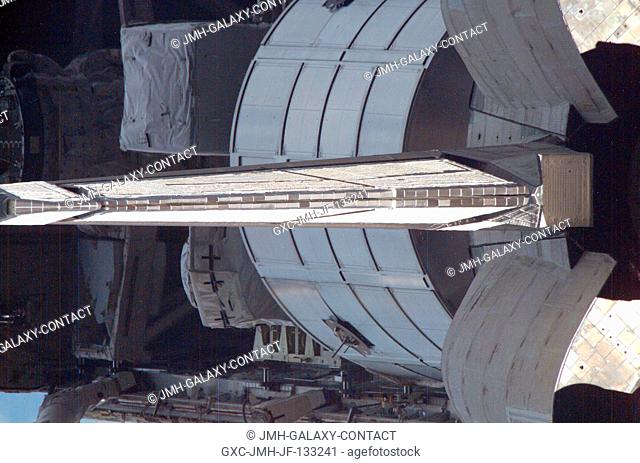 Somewhat of a different angle showing Discovery's vertical stabilizer and some of the cargo in the payload bay was provided by one of the photographs taken by...