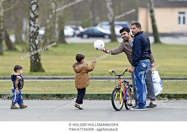 Refugees play at the site of the Camp Bad Fallingbostel Ost refugee accommodation in Bad Fallingbostel, Germany, 30 March 2016