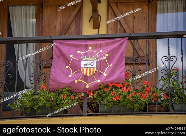 Flag of the Aran Valley, inspired by the Occitan flag, hanging from a balcony in the town of Les (Aran Valley, Lleida, Catalonia, Spain, Pyrenees)