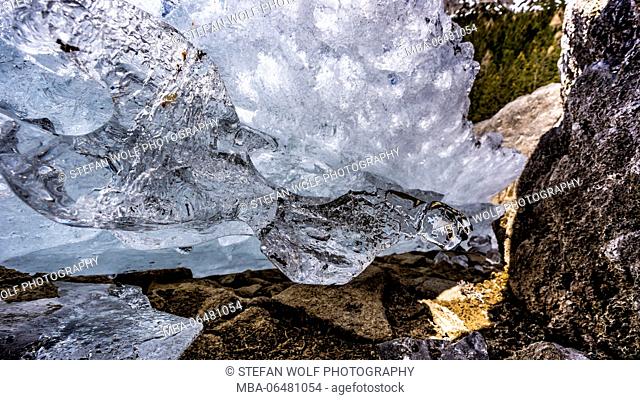 ice pieces in the Obernberger lake in winter, with Obernberg at the Brenner Pass, the Stubai Alps, Tyrol, Austria
